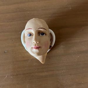 Porcelain doll face pin